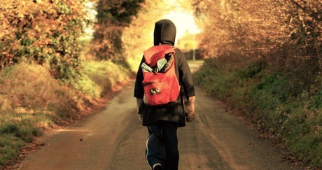 child walking along road